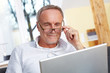 Photo : mature man with laptop and eyeglasses
