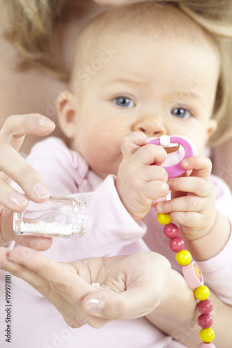 Photo: junge mama gibt ihrem baby globuli junge mama gibt ihrem baby globuli