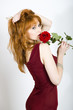 Young elegant woman with red rose