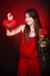 Girl with  heart, flower rose on red background. Valentines day.