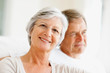 Closeup portrait of a smiling elderly couple sitting together