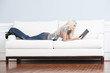 Woman Reclining on Couch With Book