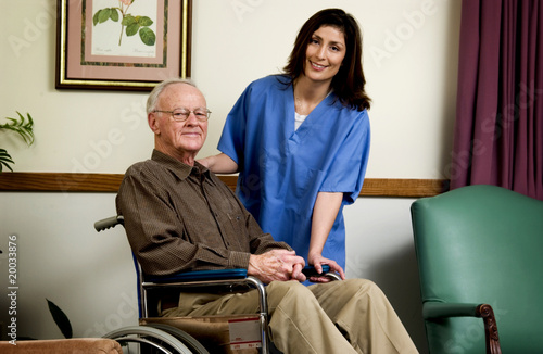 Photo: Man in wheelchair with nurse Man in wheelchair with nurse