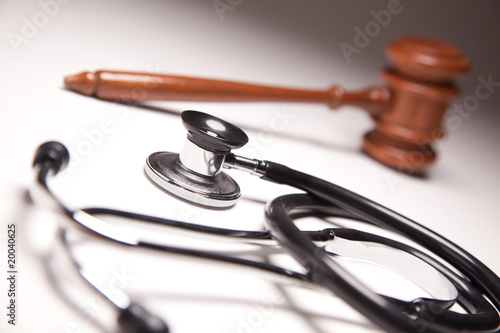 Photo: Gavel and Stethoscope on Gradated Background Gavel and Stethoscope on Gradated Background