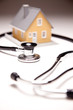 Stethoscope and Model House on Gradated Background