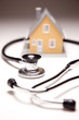 Stethoscope and Model House on Gradated Background