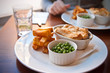 Steak and Guiness pie with peas and chips