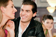 Couple in bar drinking beer flirting