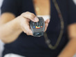 Photo: Mid section of a woman holding a television remote Mid section of a woman holding a television remote