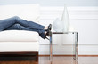 Woman's Leg's Reclining on White Couch