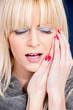 blond woman having toothache