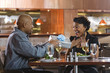 Man Giving Gift to Woman at Restaurant