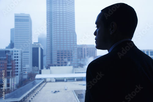 Photo: Businessman Looking Through a Window Businessman Looking Through a Window