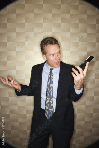 Photo: Angry Businessman on Cell Phone Angry Businessman on Cell Phone