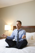 Businessman Meditating on Bed