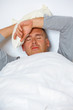Man with headache in his bed