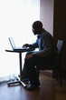 Businessman with Laptop at Cafe Table