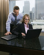 Businesspeople Looking at Laptop Computer