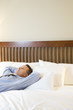 Businessman Relaxing on Bed