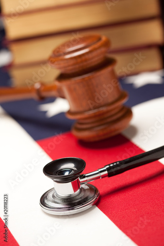 Photo: Gavel, Stethoscope and Books on Flag Gavel, Stethoscope and Books on Flag