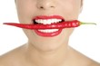 Photo: Beautiful woman teeth eating red pepper Beautiful woman teeth eating red pepper