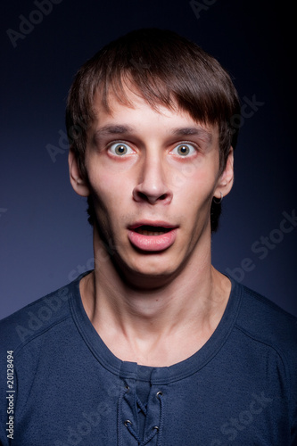 Photo: Emotional man very much surprised with her mouth open Emotional man very much surprised with her mouth open