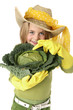 Jeune fille , bottes jaune, un choux vert et un chapeau de paill