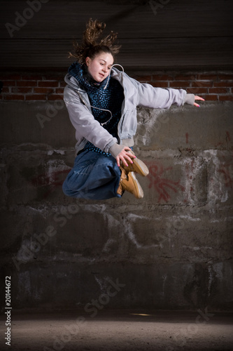 Photo: Hip hop dancer in modern style over brick wall Hip hop dancer in modern style over brick wall