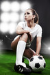 Sexy football  player, woman on playing stadium
