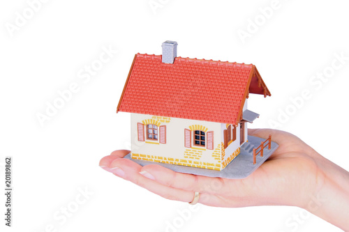 Photo: One family house in a hand One family house in a hand