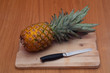 Pineapple, knife and chopping board