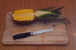 Half Pineapple, knife and chopping board