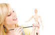 happy teenage girl with wooden model dummy