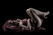very sexy woman covered with red silk sheet