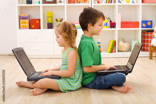 Photo: Kids with laptops - computer generation Kids with laptops - computer generation