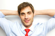 Young Businessman sitting back with his arms behind his head