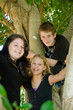 smiling teens high up in a tree smiling teens high up in a tree