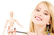 happy teenage girl with wooden model dummy