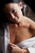 Young brunette woman in her bedroom