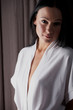 Young brunette woman in her bedroom