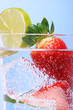 strawberries in sparkly water with ice cubes