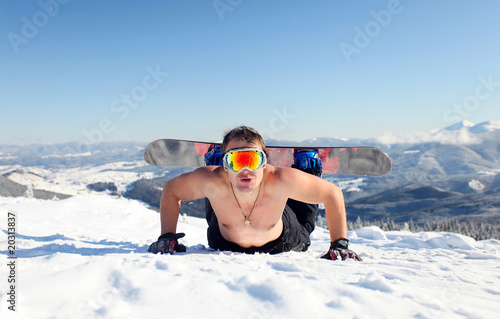 Photo: Snowboarder topless on the mountain slope Snowboarder topless on the mountain slope