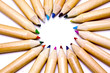 Colored pencils forming a color circle. White background.