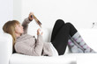Woman reading book laying on back
