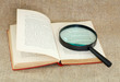Still life of magnifying glass and old book Still life of magnifying glass and old book