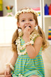 Happy little girl eating popcorn