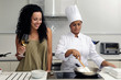 Cookery course: woman learning how to cook risotto