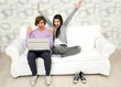 Young couple using laptop on couch