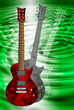 red and black electric guitars on green background