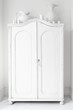Closed storage cupboard painted white